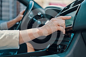 Close up of woman using global positioning system while driving car