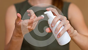 Close-up of a woman using hand moisturizing cream