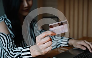 Close up woman using laptop and credit card for pay online shopping e-commerce online payment concept.