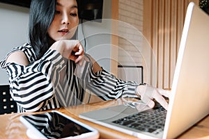 Close up woman using laptop and credit card for pay online shopping e-commerce online payment concept.