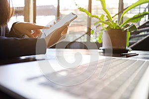 Close up of a woman using mobile smart phone on the table