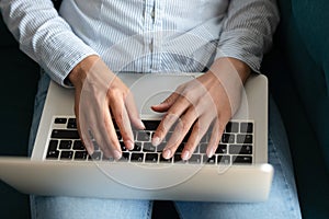 Close up of woman using modern laptop texting