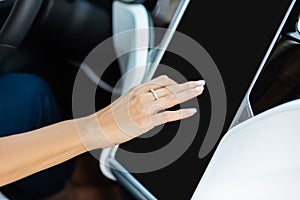 Close up of woman using navigation system in her car