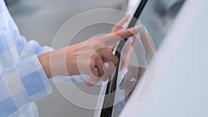 Close up: woman using touchscreen display of interactive kiosk at exhibition