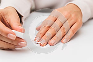 Close up woman varnishing nails at home. self nail strengthening while in quarantine