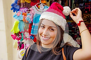 Close up of woman wearing a christmast hat in front of souvenir store in the Passage Craft in the downtown of the city photo