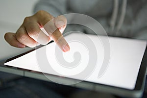 Close up of woman wearing grey casual shirt hand holding and using tablet.  Woman chatting about something for social media