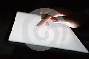 Close up of woman wearing grey casual shirt hand holding and using tablet.  Woman chatting about something for social media