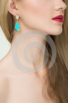 Close up of woman wearing shiny diamond earrings