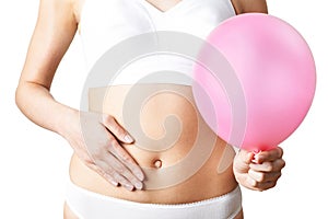 Close Up Of Woman Wearing Underwear Holding Pink Balloon And Touching Stomach