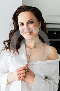 Close-up woman wears massive chain on neck, metal necklace. Modern jewellery concept