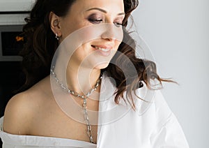 Close-up woman wears massive chain on neck, metal necklace. Modern jewellery concept