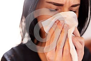 Close up of woman with wipe crying at funeral