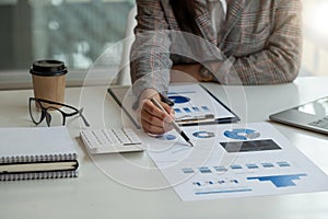 Close up a woman working about financial with calculator at her office to calculate expenses, Accounting business