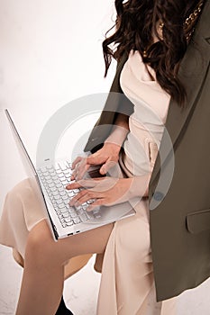 Close-up of a womans hand on the laptop keyboard, Technology and internet communication. Business lady in elegant dress