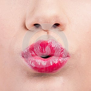 Close up of womans pouting lips with lipstick