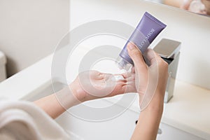 Close up of women applying body lotion cream on hand