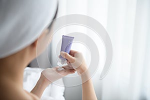 Close up of women applying body lotion cream on hand