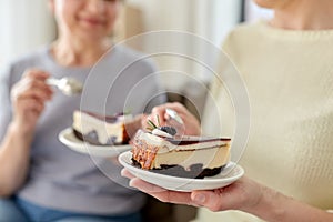 Close up of women eating cake at home