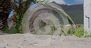 Close-up of women feet in white sneakers walking down the path in the village Masca Gorge, Tenerife, Canary Island