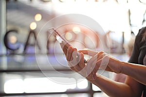 Close up of women`s hands holding smarthone and watching sms