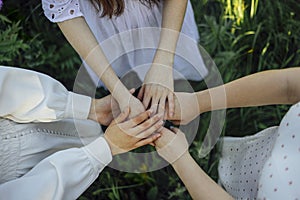 Close up of a woman's hand touching the grass, feeling nature