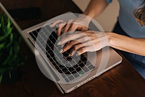 Close-up of women`s hands are typing on the laptop keyboard, an enters password