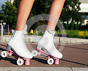 Close-up of women`s legs dressed in fashionable vintage roller skates derby quads photo