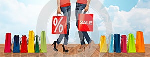 Close up of women with sale sign on shopping bag