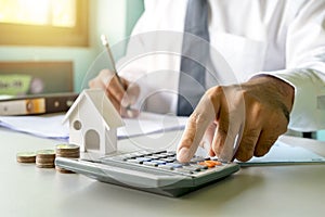 Close-up of women using calculators and note-taking, accounting reports