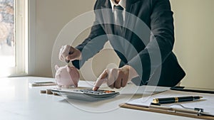 Close-up of women using calculators and note-taking, accounting reports