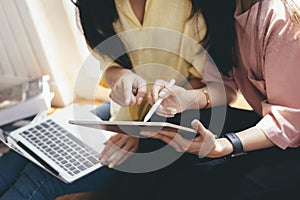 Close up women using online mobile gadget together