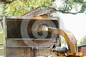 Close up of a wood chipper machine chipping wood.