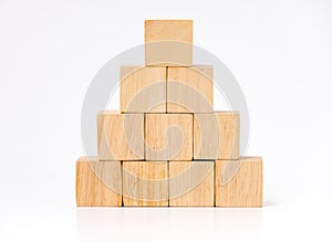 Close up at wood cube arrange in pyramid shape ,business concpt photo