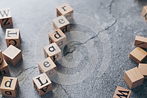 Close up of wood cube letter word of leader. Idea of motivation and inspiration in business success and corporate management