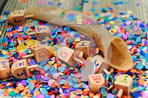 Close up of wood dreidels and chocolate coins for Hanukkah celebration. Caps following words