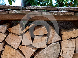 Close up of wood stack with a little roof. wood pile