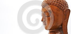 Close-up Wooden buddha head, isolated on white background with copyspace