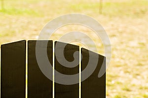 Close-up of wooden chair in green landscape park