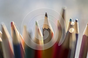 Close up of wooden colorful pencils, group of scattered crayons