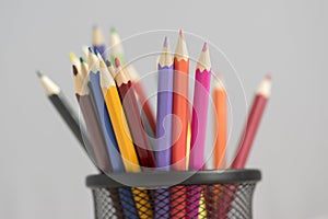 Close up of wooden colorful pencils, group of scattered crayons, isolate od white background