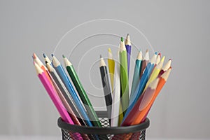 Close up of wooden colorful pencils, group of scattered crayons, isolate od white background