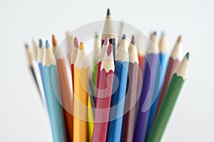 Close up of wooden colorful pencils, group of scattered crayons, isolated od white background