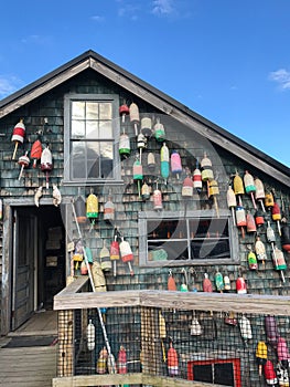 Close up of a wooden cottage with lobster buoys hanging on it on Mt Desert Island, Maine, USA