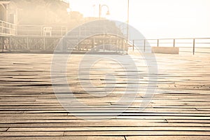 Close up on a wooden deck with overexposed background with copy space