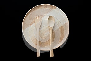 Close up wooden dish ,spoon and fork on black background