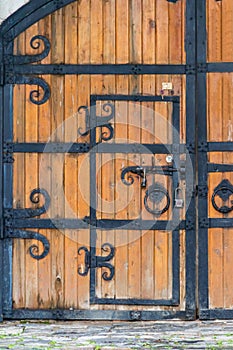 Close-up of wooden gate with wrought iron elements