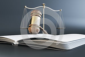 Close up of wooden gavel, scales and book/journal on gray background. Lawyer, justice and punishment concept.