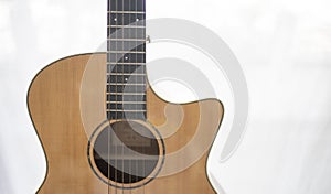 Close up of wooden guitar showing in living room at home