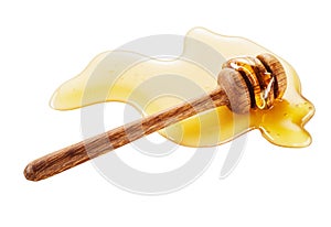 Close-up of wooden honey dipper on white